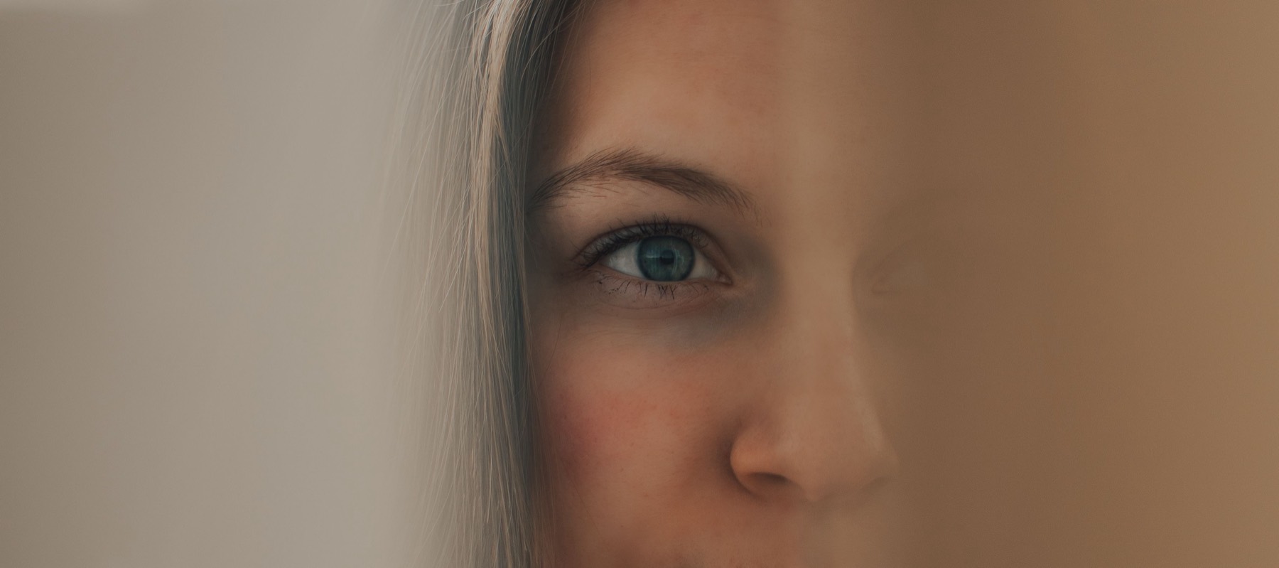A close-up of a woman looking steadily to one side, echoing the guided eye movements used in EMDR.